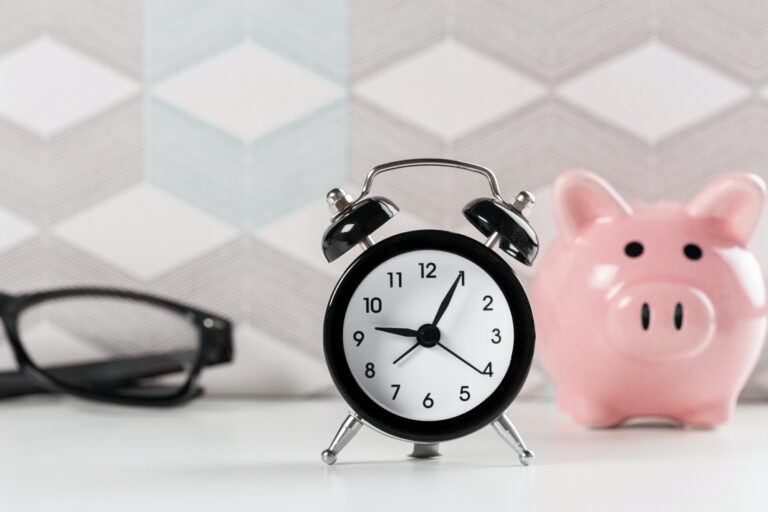 Alarm clock and piggy bank concept for saving for a house down payment
